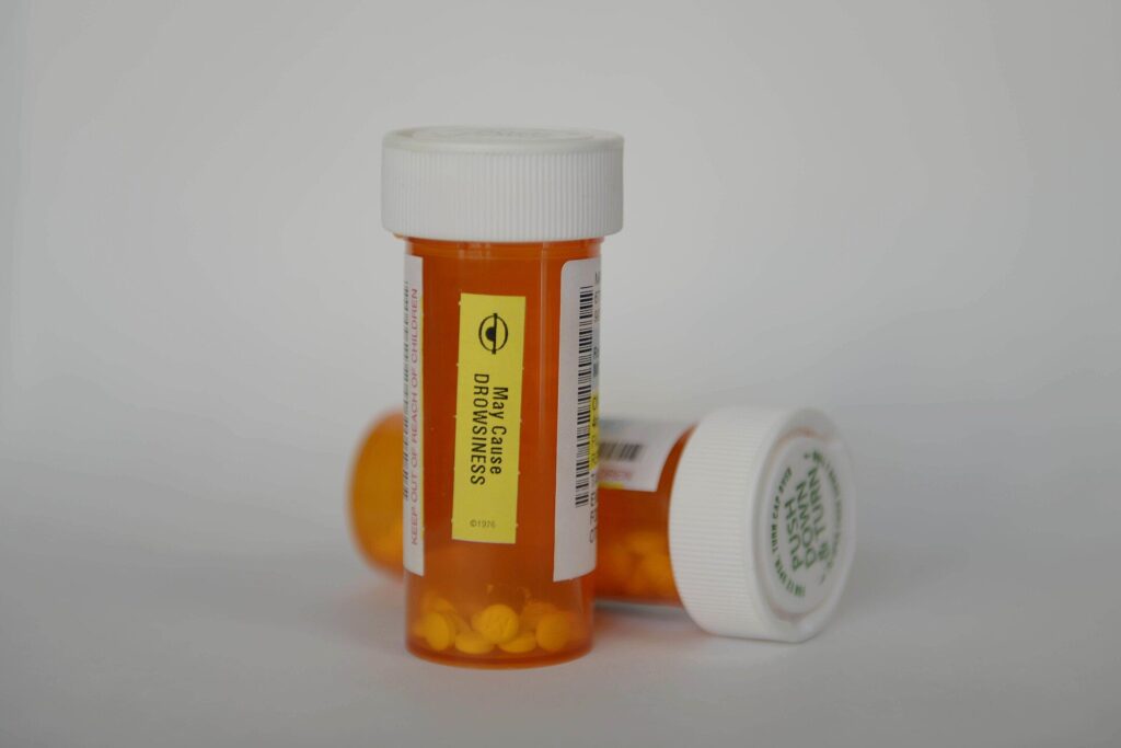 Orange prescription pill bottles with white caps, the kind of unused medication accepted on Drug Take Back Day