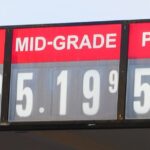Gas station price sign showing unleaded at $4.79, mid-grade at $5.19 and premium at $5.59 a gallon