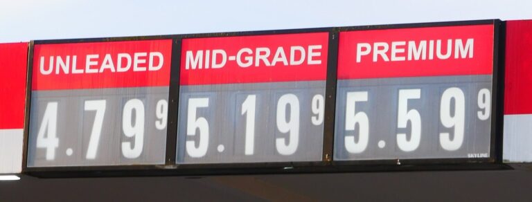 Gas station price sign showing unleaded at $4.79, mid-grade at $5.19 and premium at $5.59 a gallon