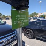 Green Publix and Instacart pickup parking sign in a grocery store parking lot