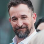 Noah Wyle smiling at his Hollywood Walk of Fame star ceremony in 2026
