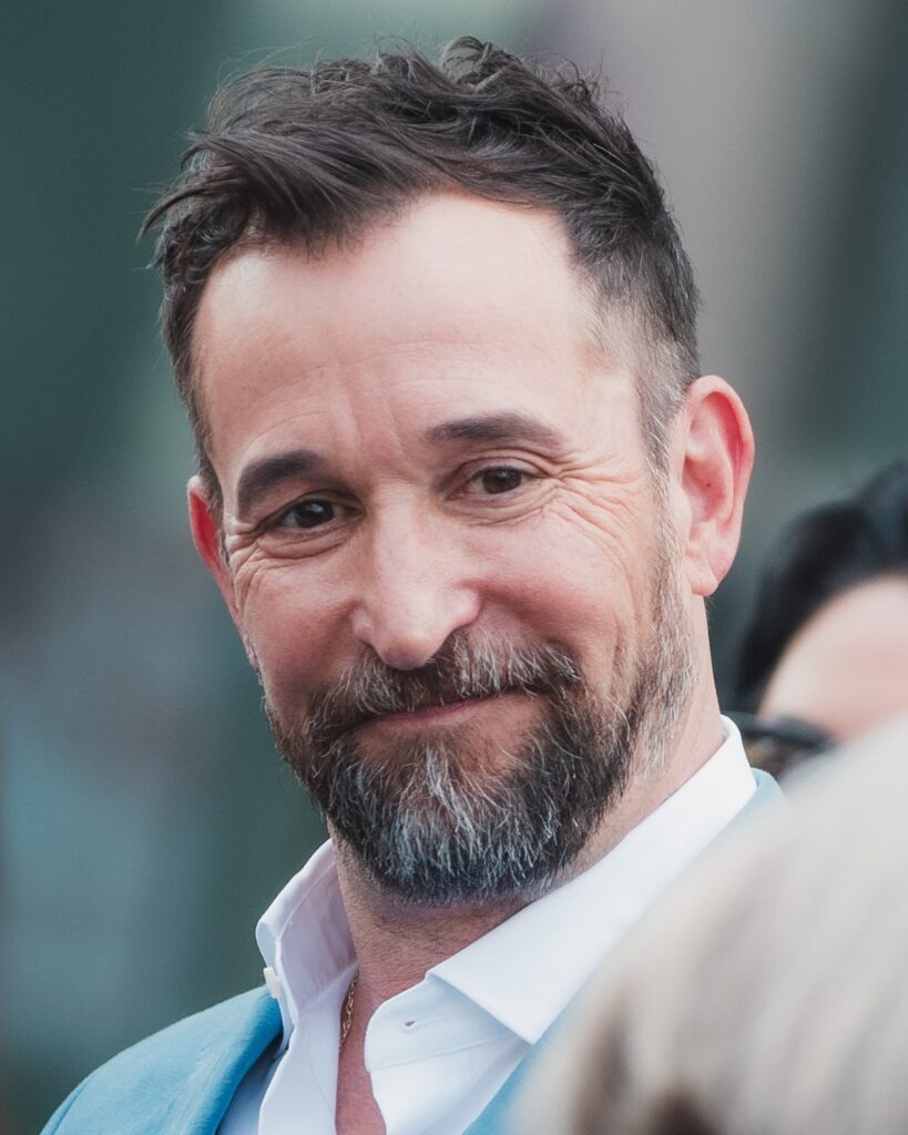 Noah Wyle smiling at his Hollywood Walk of Fame star ceremony in 2026